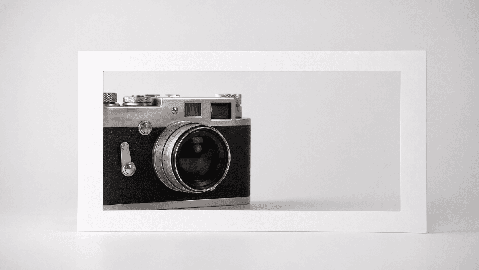 Printed 16:9 photo frame on a neutral studio surface for thumbnail cropping