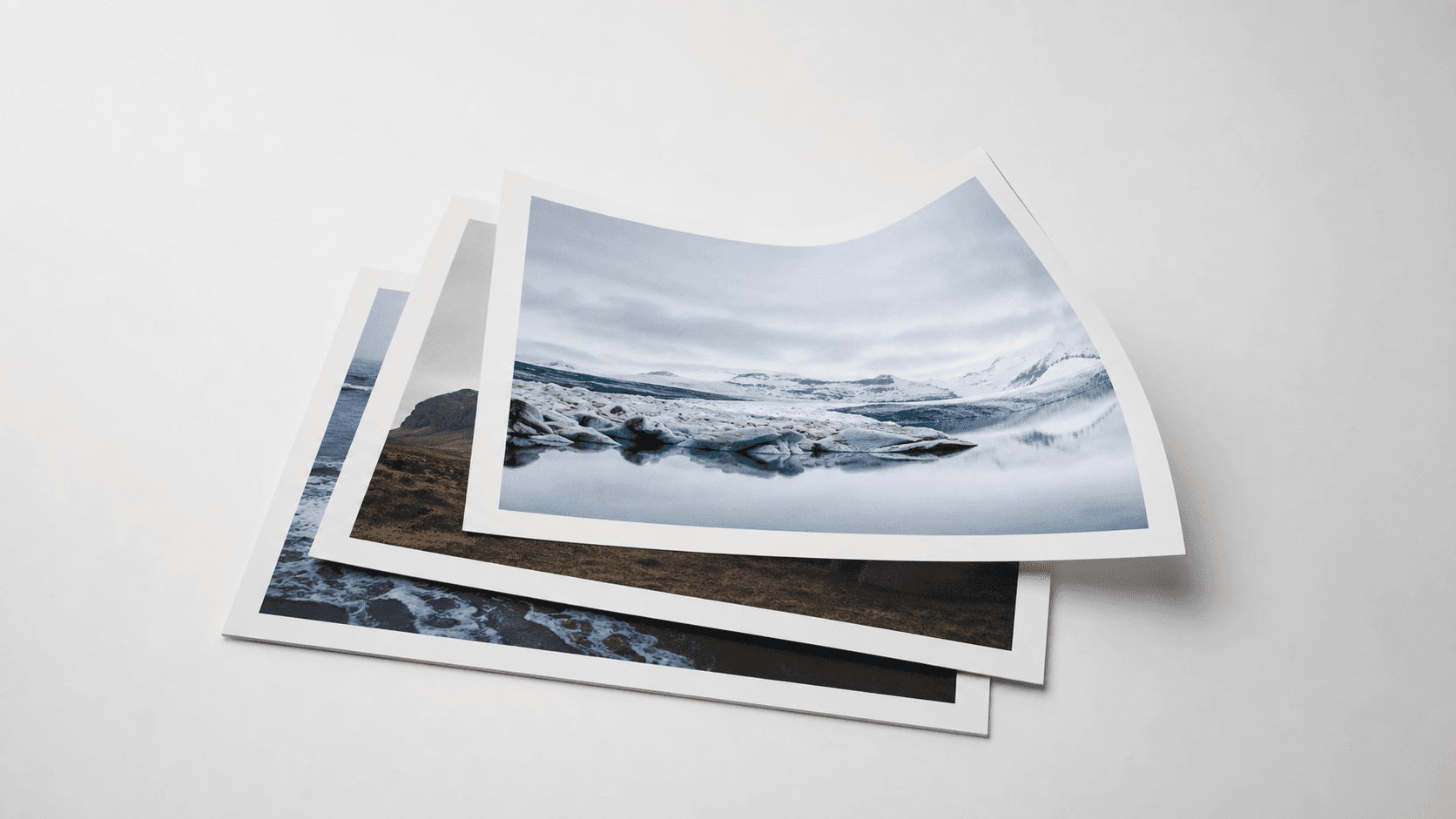 Printed photos stacked into a clean document bundle on a neutral studio surface